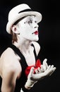 Mime with red bow ina white hat and striped gloves