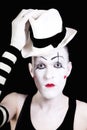 Mime with red bow ina white hat and striped gloves