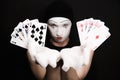 Mime with royal flush on a black background Royalty Free Stock Photo