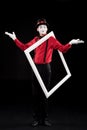 mime showing shrug gesture and holding frame on shoulder