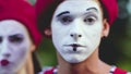 Mimes crooking face in funny ways