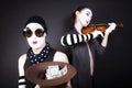 Mimes playing a violin for the money Royalty Free Stock Photo
