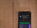 Mimo - Learning coding app play store page on the display of a black mobile smartphone on wooden background