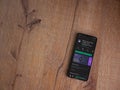 Mimo - Learning coding app play store page on the display of a black mobile smartphone on wooden background