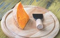 Mimolette cheese on the wooden board