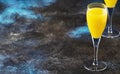 Mimosa alcohol cocktail with orange juice and dry champagne or sparkling wine in glasses, blue background, copy space