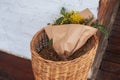 Mimosa bouquet in wicker basket. Bunch of yellow flowers on veranda home. Decor spring terrace. Home decor in rustic style. Cozy