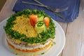 Mimosa Salad. Layers of carrots, fish, potatoes and grated hard-boiled egg, covered with mayonnaise