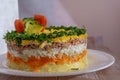 Mimosa Salad. Layers of carrots, fish, potatoes and grated hard-boiled egg, covered with mayonnaise