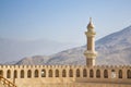 Minaret behind a wall of a fort in Nizwa