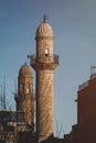 Minaret of a historical mosque in mardin turkey and white background Royalty Free Stock Photo