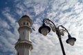 Minaret Kapitan Keling Mosque with the street lamp under blue sky.