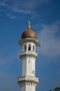 Minaret Kapitan Keling under blue sky.