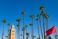 Koutoubia Mosque and Palm Trees with the Moroccan Flag in Marrakesh Morocco Royalty Free Stock Photo