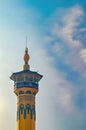 the minaret of a mosque against a backdrop of blue sky and cloudy twilight Royalty Free Stock Photo