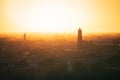 minaret of the mosque against the background of the bright orange sun during the evening sunset. Royalty Free Stock Photo