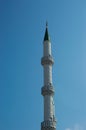 Minaret of the mosque against the blue sky Royalty Free Stock Photo
