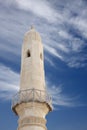 Minaret of mosque with ancient wooden fence Royalty Free Stock Photo