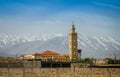 Minaret of mosque in Midelt with Atlas mountain in background in Morocco