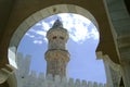 Minaret of the mosque seen through the arch in Senegal Royalty Free Stock Photo