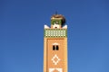 Minaret of mosque with storks` nest on the top in Morocco