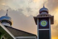 Minaret or mosque tower under the orange sky, for islamic new year greetings or ramadan kareem