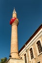 Minaret on a mosque with Turkish flag Royalty Free Stock Photo