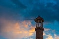 Minaret of an old mosque against the sunset sky Royalty Free Stock Photo