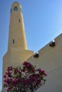 Minaret of Qatar State Mosque with Bougainvillea Royalty Free Stock Photo