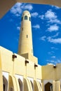Minaret of mosque with white clouds and blue sky Royalty Free Stock Photo