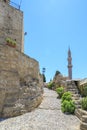 Minaret of suleiman`s mosque view from under medieval clock tower Rhodes Royalty Free Stock Photo