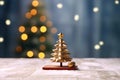 Minature golden Christmas tree on wooden table with snow and blurred beautiful light bokeh, Christmas background. Generative AI Royalty Free Stock Photo