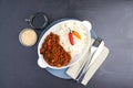 Mince, chili and rice for plate on dark background with Mexican menu, cutlery and healthy dinner. Chili con carne Royalty Free Stock Photo