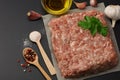 Mince. Ground meat with spices on black background. Top view