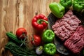 Mince and peppers. Ingredients for stuffed peppers. Two types of minceand and bell pepper.On a wooden background. Royalty Free Stock Photo