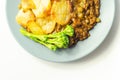 Minced beef hotpot, tender british beef in a warming gravy with carrots and peas, all topped with sliced roast potatoes Royalty Free Stock Photo