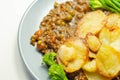 Minced beef hotpot, tender british beef in a warming gravy with carrots and peas, all topped with sliced roast potatoes Royalty Free Stock Photo