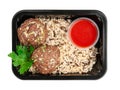 Minced beef meatballs with brown rice and tomato sauce. In a food delivery container. White background. View from above. Isolated Royalty Free Stock Photo