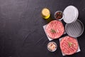 Minced beef steak burgers with spices. Raw fresh hamburger patties or cutlet ready to cook Royalty Free Stock Photo