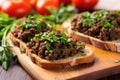 minced black olive tapenade on small bruschetta pieces