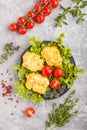 Minced chicken cutlets with lettuce, tomatoes and herbs on a gray concrete background. top view Royalty Free Stock Photo