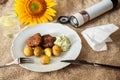 Minced meat balls, potato and dip, open salt cellar and sunflower Royalty Free Stock Photo
