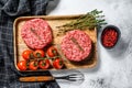 Minced meat burger cutlets. Gray background. Top view Royalty Free Stock Photo
