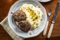 Minced meat cutlets with mashed potatoes topped with clarified butter. Traditional Slovak meatballs - Fasirky with potato puree