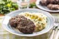 Minced meat cutlets with mashed potatoes topped with clarified butter. Traditional Slovak meatballs - Fasirky with potato puree