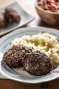Minced meat cutlets with mashed potatoes topped with clarified butter. Traditional Slovak meatballs - Fasirky with potato puree