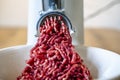 Minced meat and electric meat grinder. Cooking beef minced in the kitchen with an electric grinder Royalty Free Stock Photo