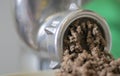 Minced meat in a manual mechanical meat grinder. Fresh boiled meat is ground with an old metal meat grinder, close-up in the Royalty Free Stock Photo