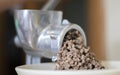 Minced meat in a manual mechanical meat grinder. Fresh boiled meat is ground with an old metal meat grinder, close-up in the Royalty Free Stock Photo