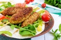 Minced meat on skewers - lula kebabs on a plate with fresh vegetables and greens